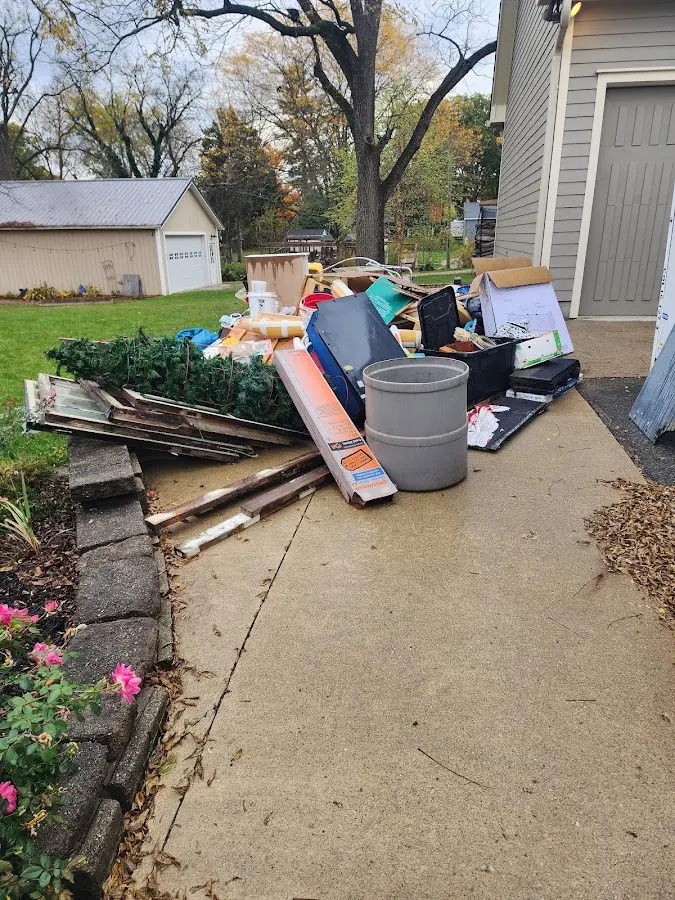 Dumpster being loaded with debris for 12 Yard Dumpster Rental in St. Bernard